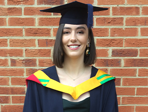 Happy student smiling in her cap and gown